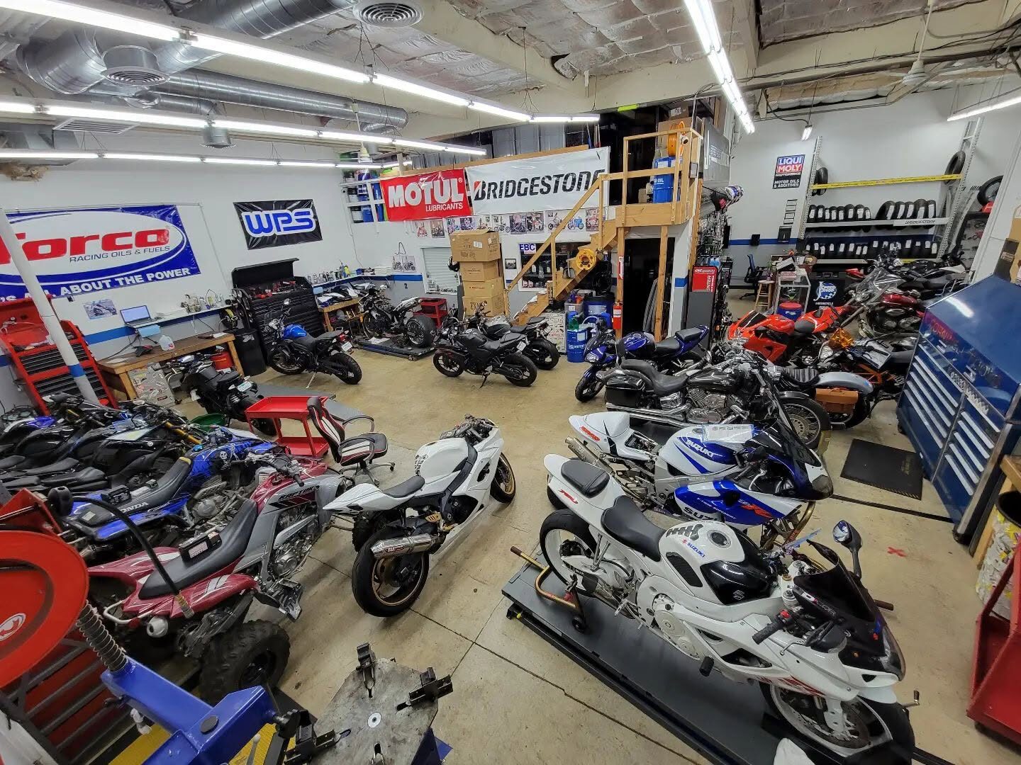 Wide view of the shop floor full of motorcycles